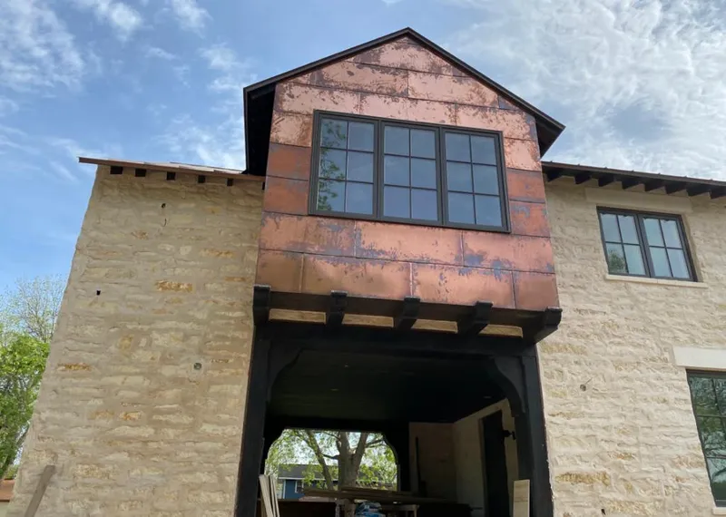 Copper metal panel facade on a stone building for Roof Repair in Pea Ridge